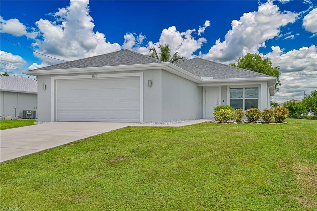 Beautiful curb appeal with a spacious 2-car garage, attractive landscaping, and a modern exterior designed for low-maintenance Florida living.