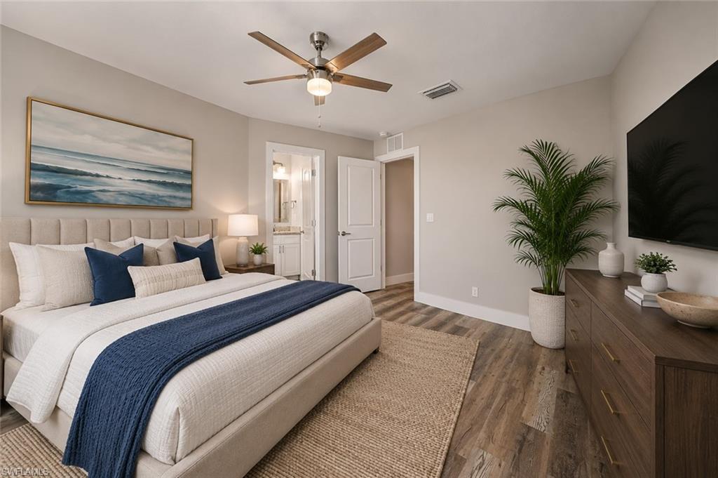 Retreat to the spacious primary suite featuring a private en-suite bath, tray ceiling, luxury vinyl plank flooring, and abundant space for oversized furnishings. [Virtually Staged]