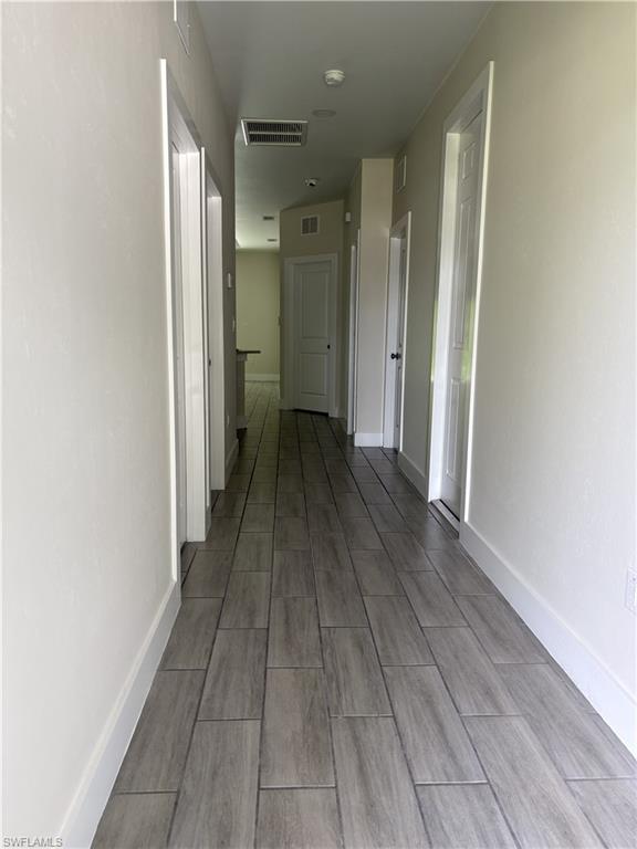 Porcelain tile flooring, white interior doors, and a neutral wall palette
