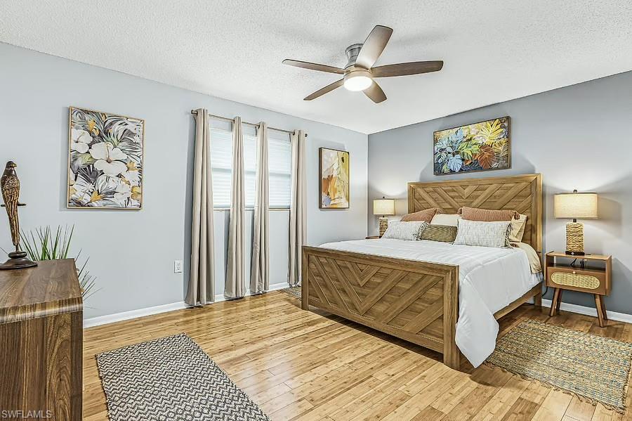 Recessed lighting, ceiling fan, wood-finish flooring, multiple windows, and light-toned walls