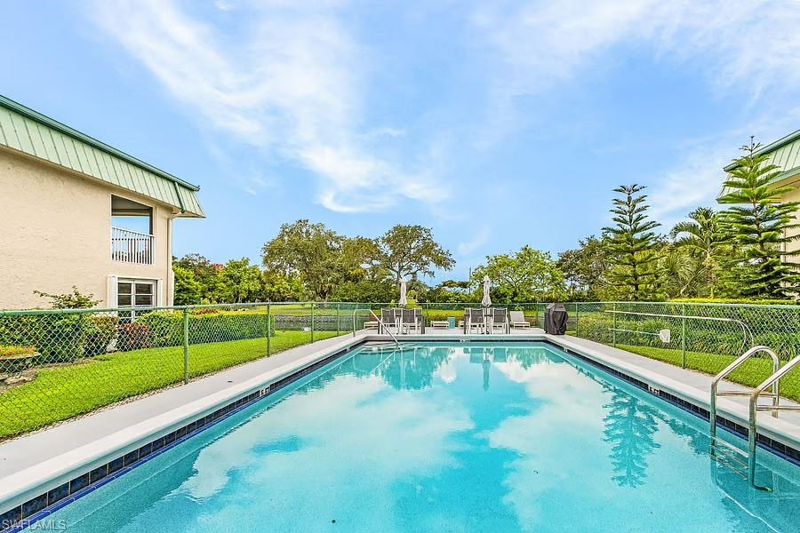 Rectangular swimming pool with integrated steps and a surrounding concrete deck