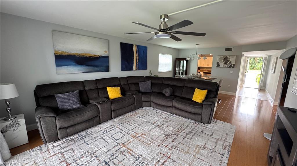 Hardwood-finish flooring, recessed lighting, and a ceiling fan with integrated lighting