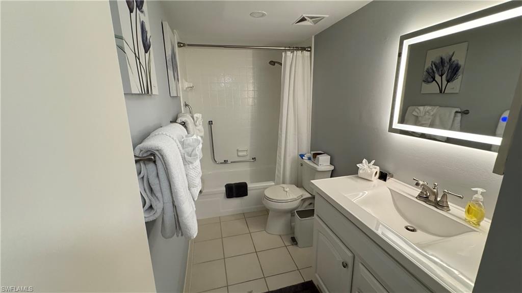Vanity with integrated sink, chrome faucet, and under-cabinet storage