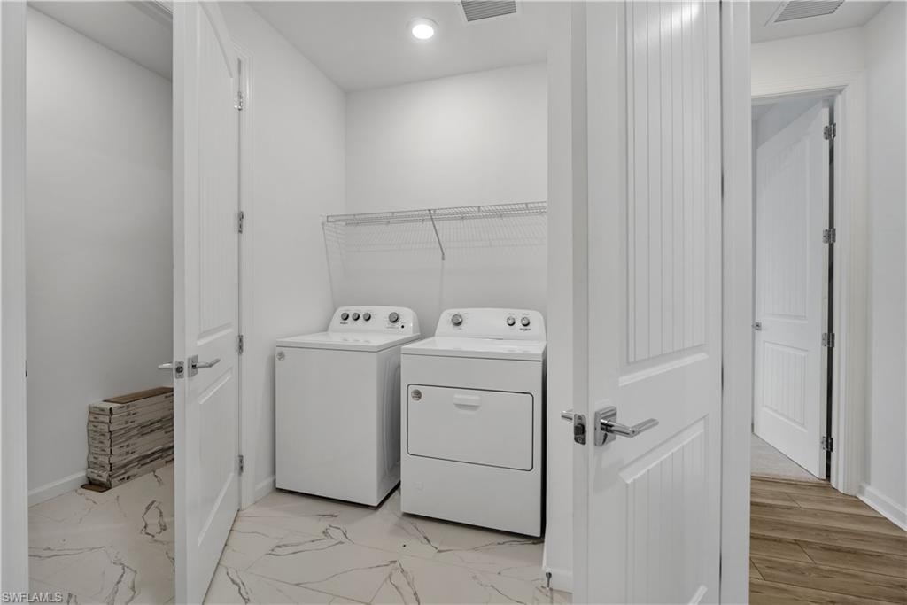 Utility room with white walls, recessed lighting, and wire shelving