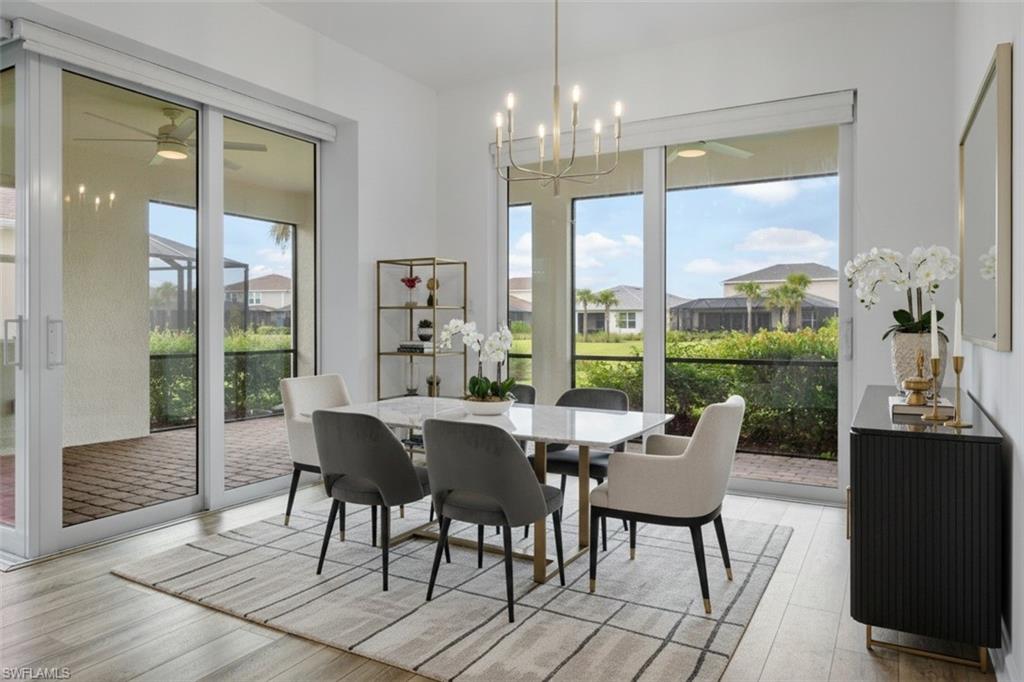 Wood-finish flooring with an open-concept dining area featuring a modern chandelier