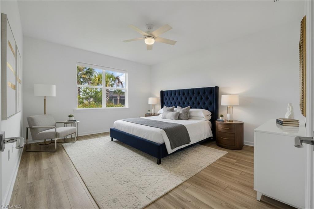 High ceilings, recessed lighting, wood-finish flooring, and a ceiling fan with light fixture