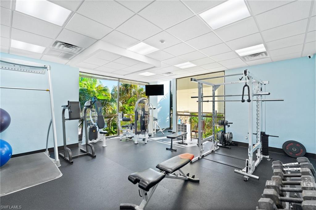 Fitness area featuring rubber flooring, recessed lighting, and expansive windows