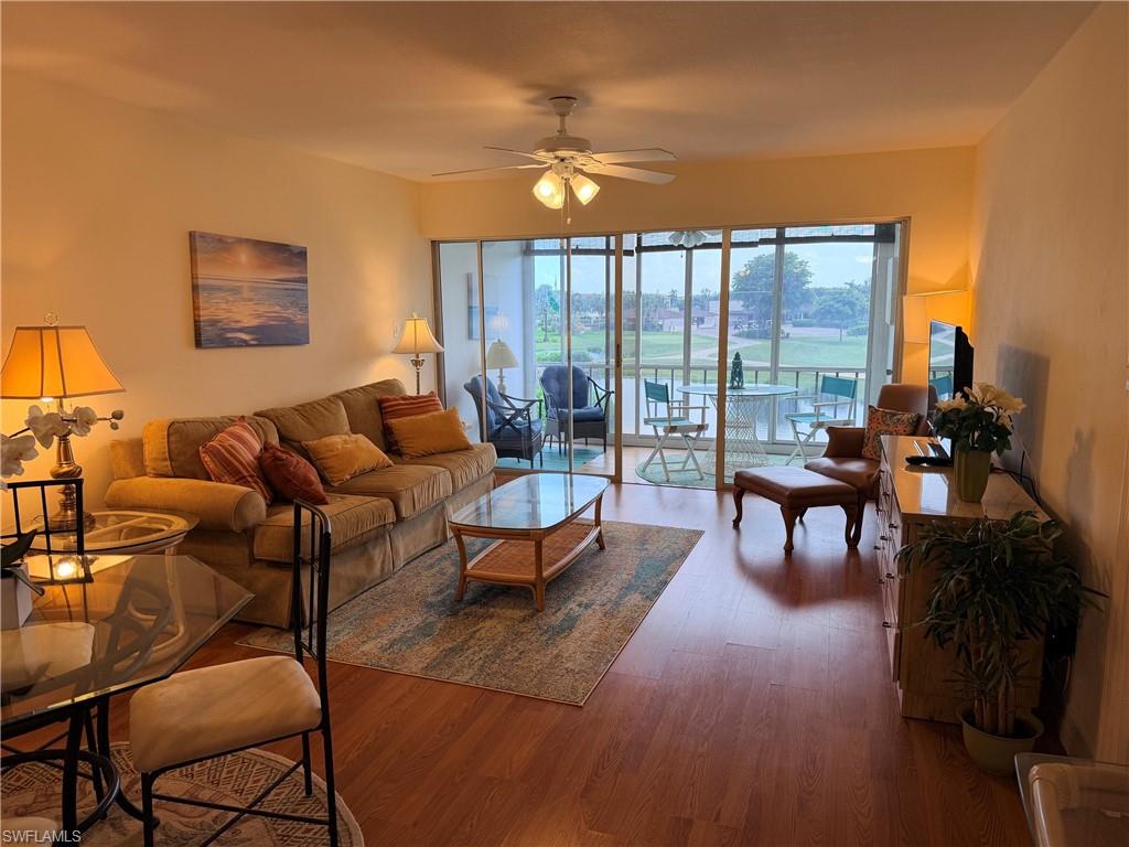 Wood-finish flooring throughout, with a ceiling fan in the living area
