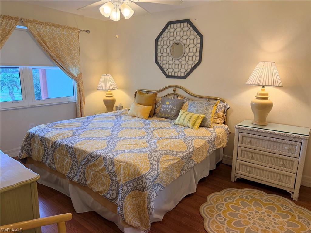 Wood-finish flooring, ceiling fan, and window with exterior view