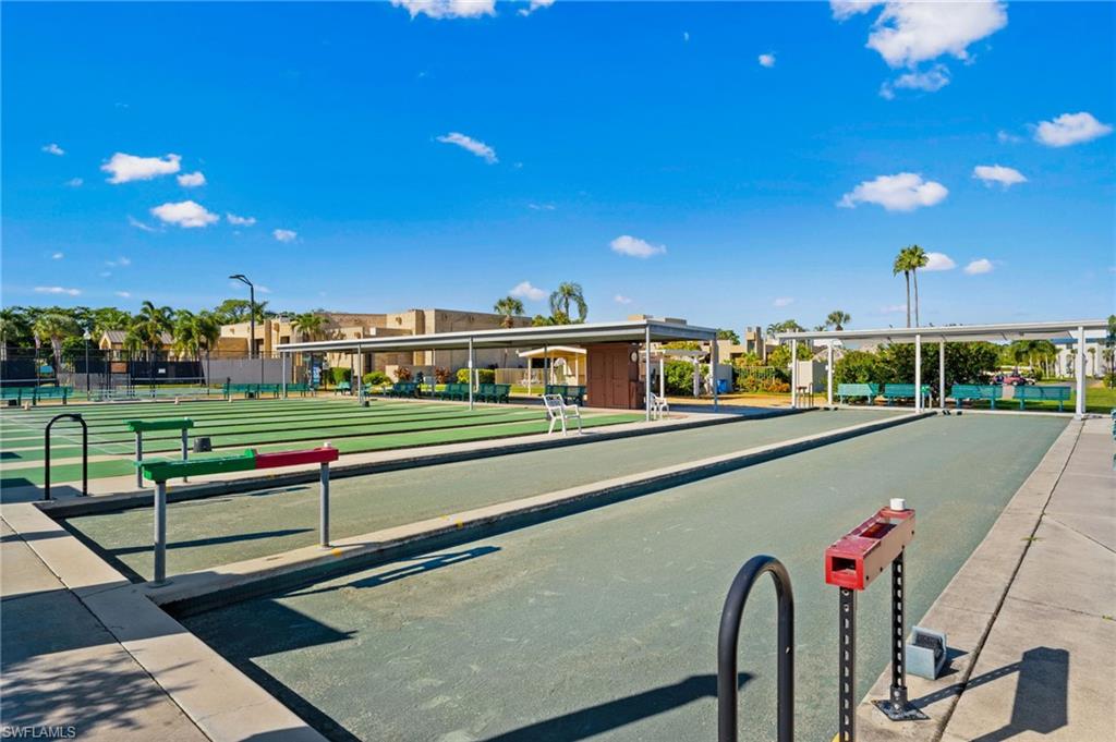 Bocce ball courts with shaded seating areas and surrounding mature landscaping