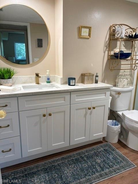 Bathroom vanity featuring a rectangular undermount sink, a gold-toned faucet, and a quartz-finish countertop