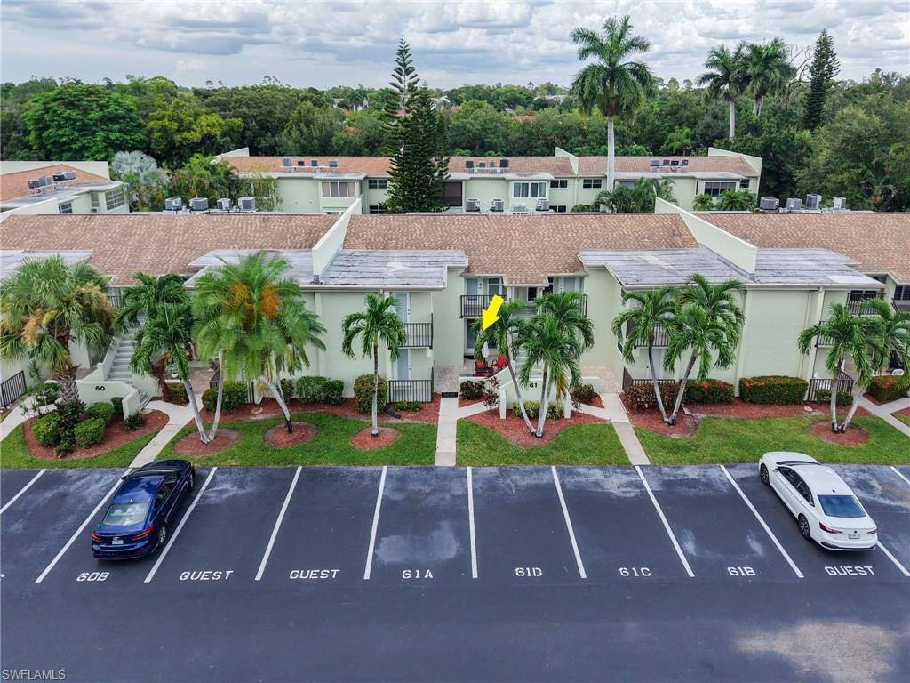 Multi-story building featuring established landscaping, and balconies