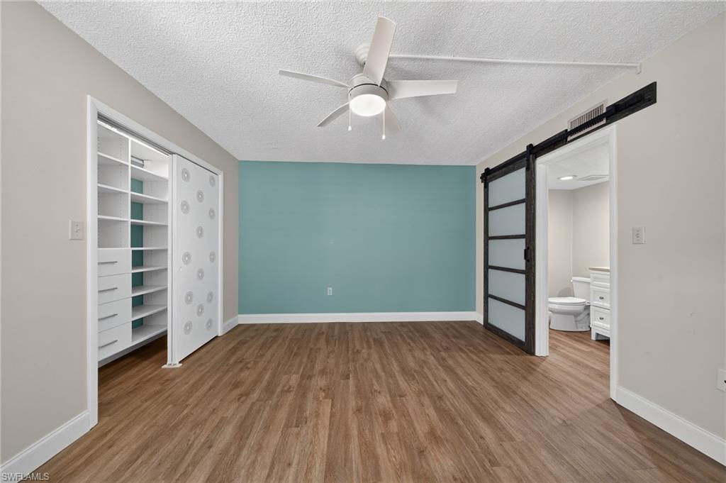 Primary bedroom with a contrasting accent wall