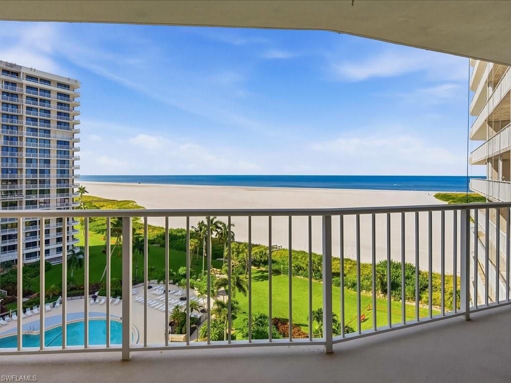Balcony with white metal railings and expansive oceanfront scenery