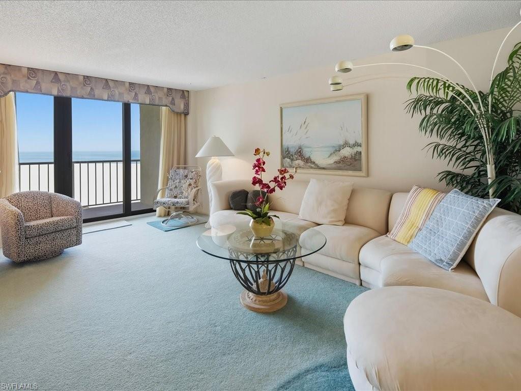 Sliding glass doors, balcony access, and light-colored wall paint