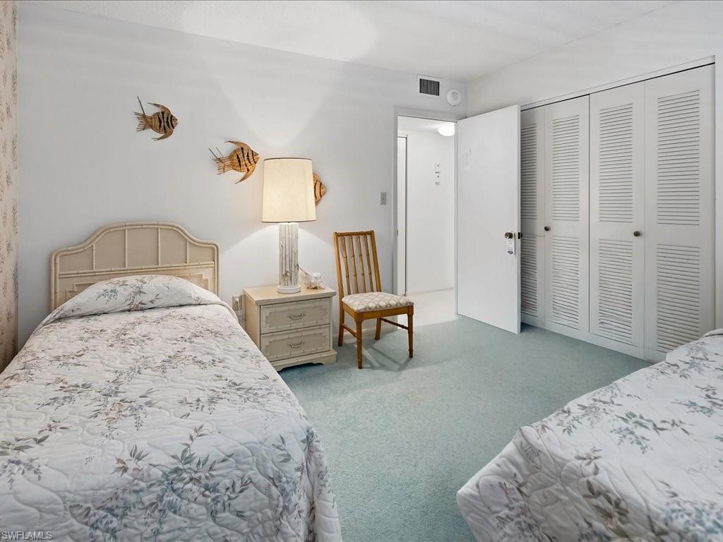 Wall-to-wall carpeting and white walls with a textured accent wall
