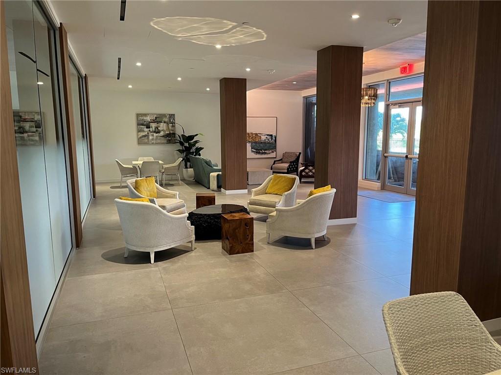 Expansive tile flooring throughout, featuring wood-finish columns and built-in wall panels
