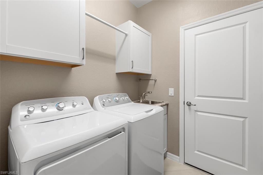 LAUNDRY ROOM WITH A SINK AND STORAGE