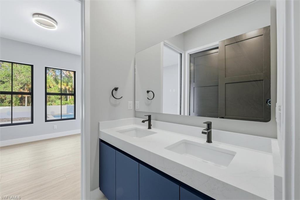 Dual vanity with integrated sinks, white countertop, and matte black fixtures