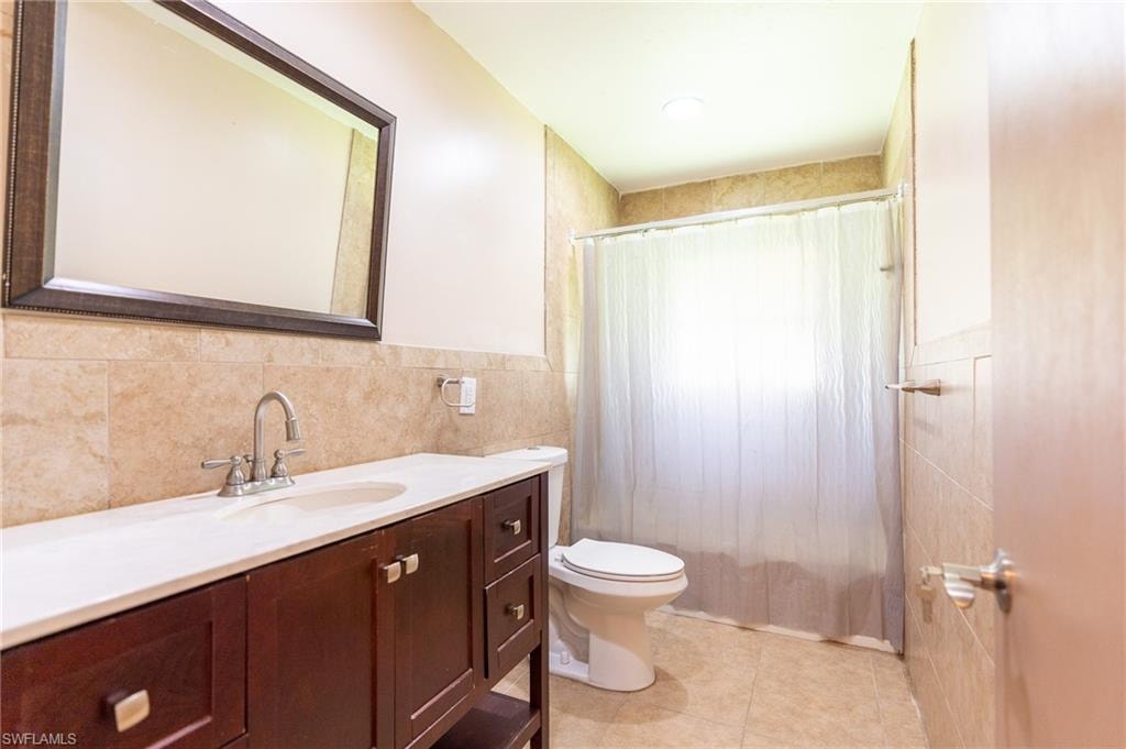 Wood-finish vanity with a white countertop and undermount sink