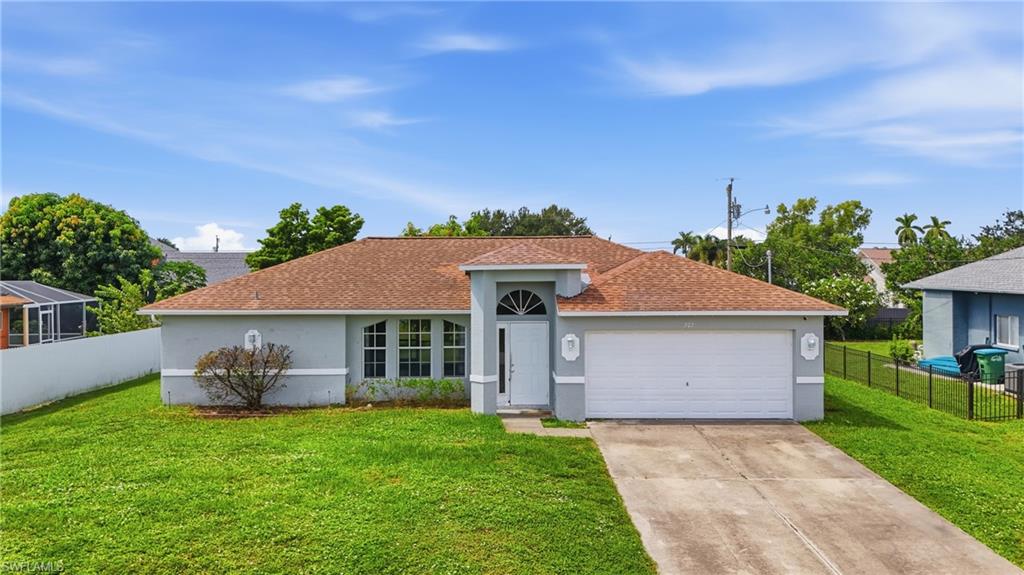 Single-story residence with an attached garage, arched entry, and a covered porch