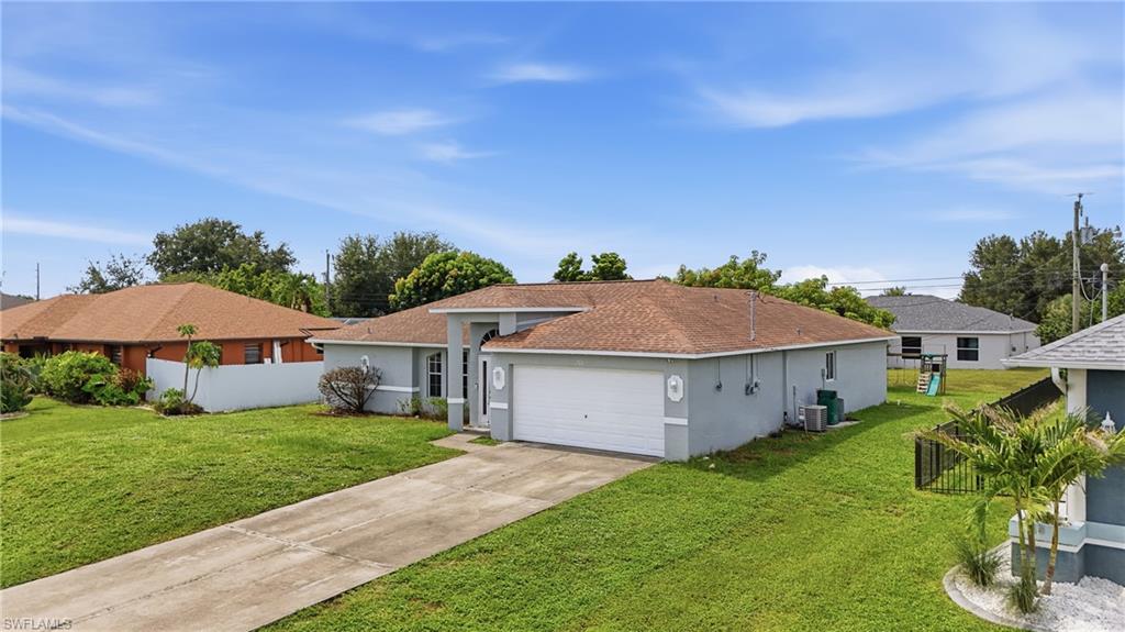 Single-story residence featuring a concrete driveway, attached garage, and a neutral exterior finish