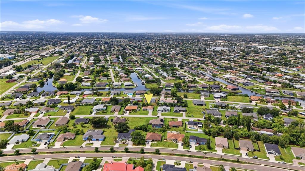 Residential neighborhood with multiple canals and a clear sky backdrop