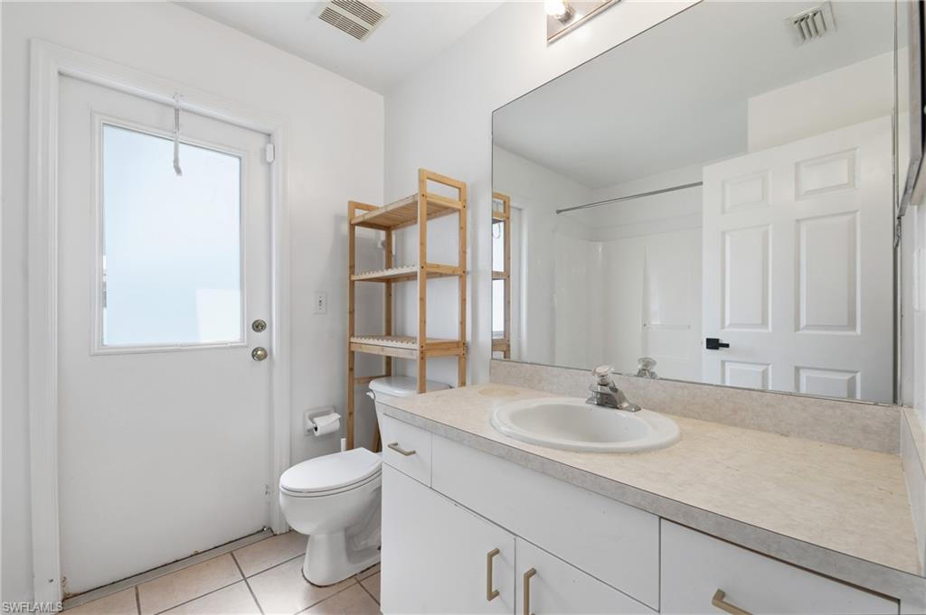 White vanity with an integrated sink and light-toned countertop