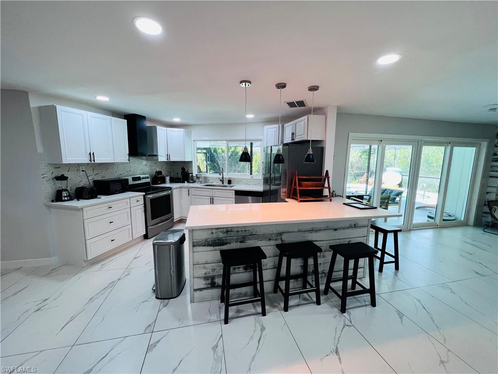 Recessed ceiling lighting, white tile flooring, ceiling fan, louvered closet doors, and window with vertical blinds
