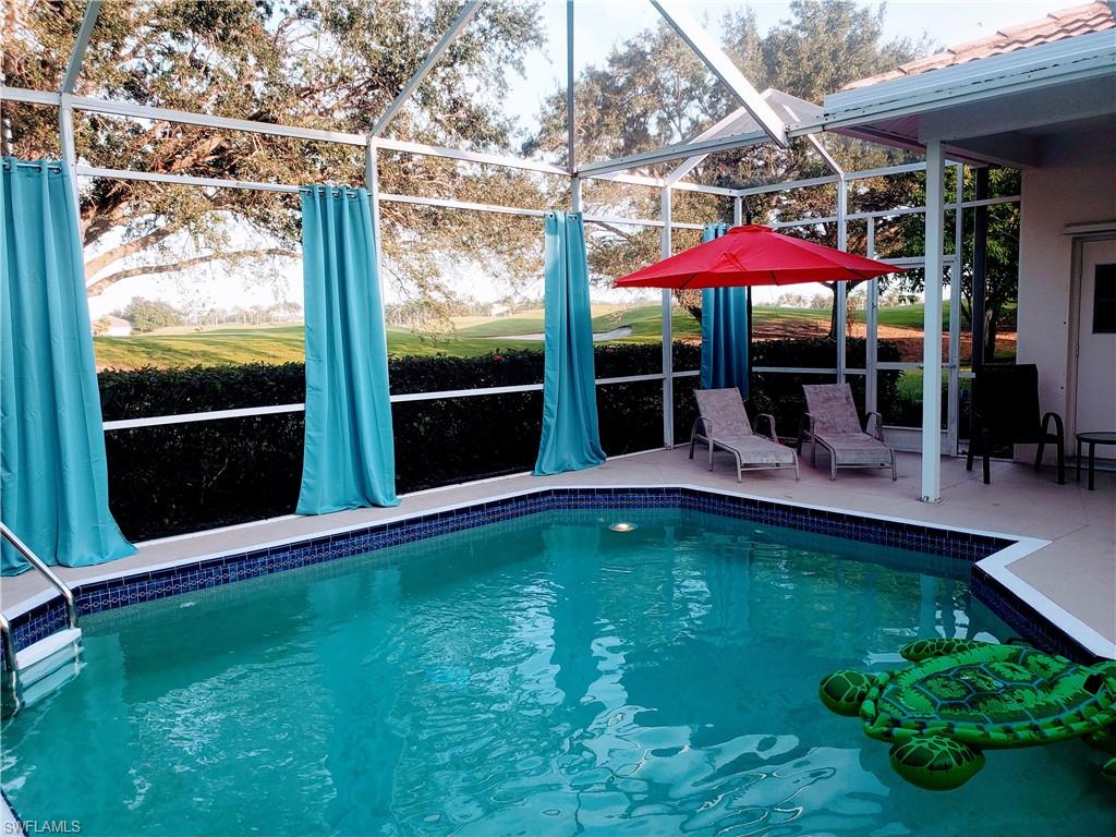 View of pool featuring lanai enclosure and a patio area