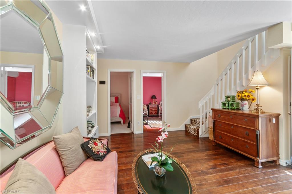 Living room featuring stairs and dark wood finished floors