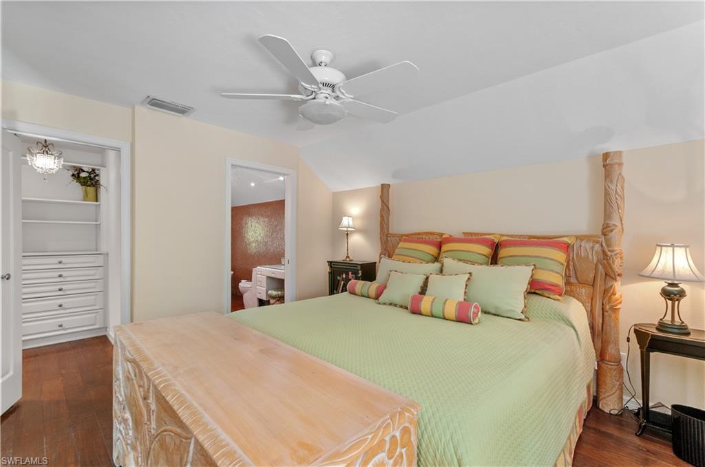 2nd floor main Bedroom featuring vaulted ceiling, ceiling fan, dark wood-style floors, and ensuite bathroom and many built in-storage