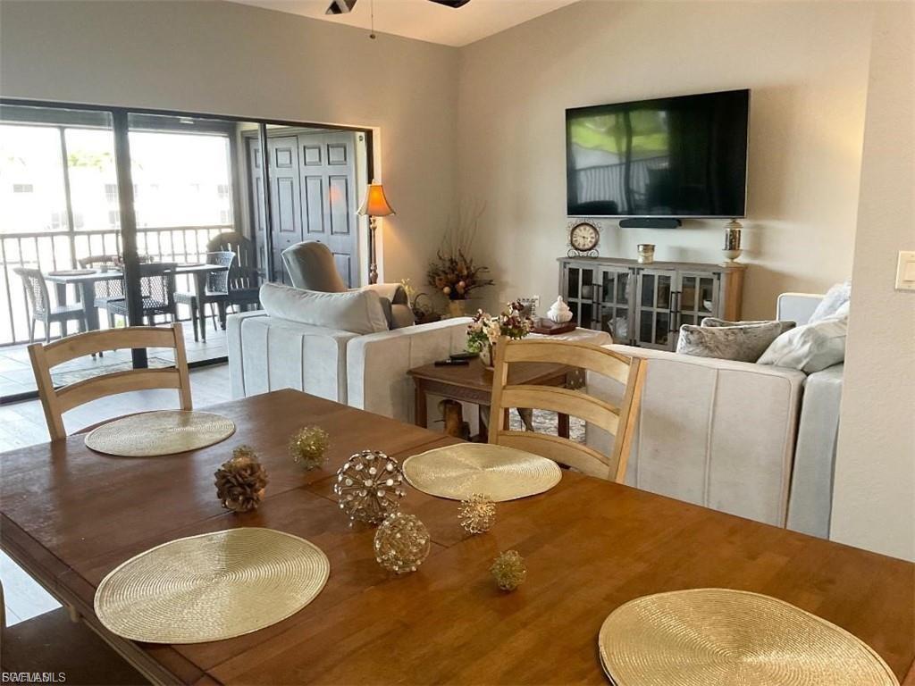 Open living area with wood-finish flooring and a screened balcony