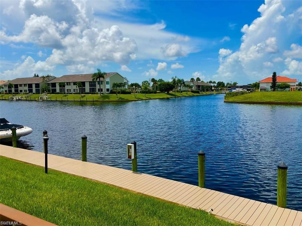 Waterfront setting with composite decking and mooring posts, overlooking a serene pond