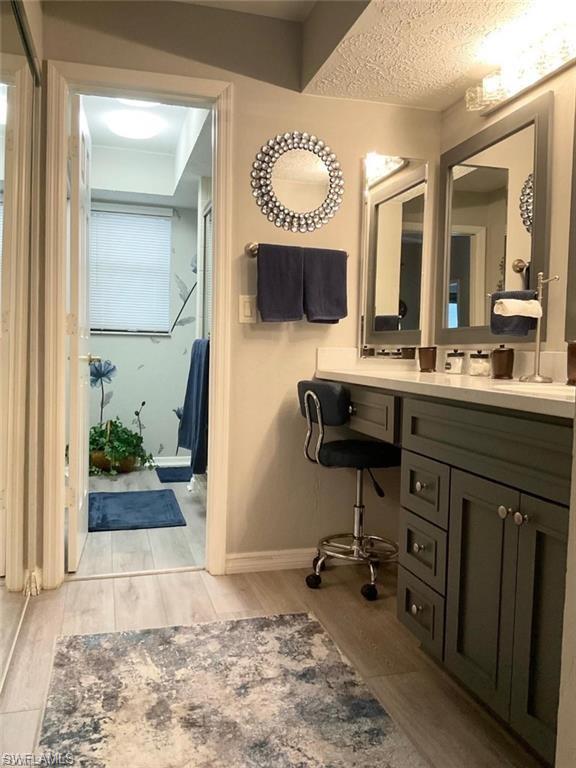Dual vanity with framed mirrors, integrated lighting, and ample cabinet storage