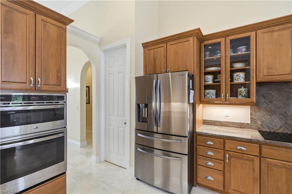 A sizable pantry is located to the left of the refrigerator.