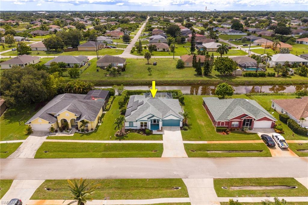 Single-story residence with a light blue exterior, two-car garage, and a concrete driveway