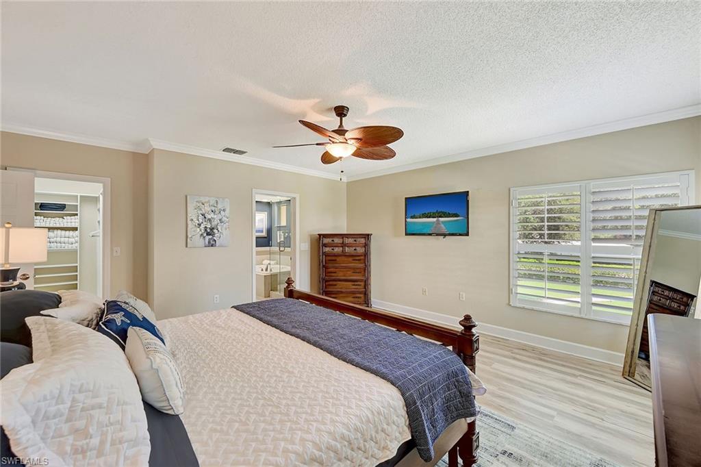 Primary Bedroom with Mounted TV, En Suite Bath and Walk-in Closet