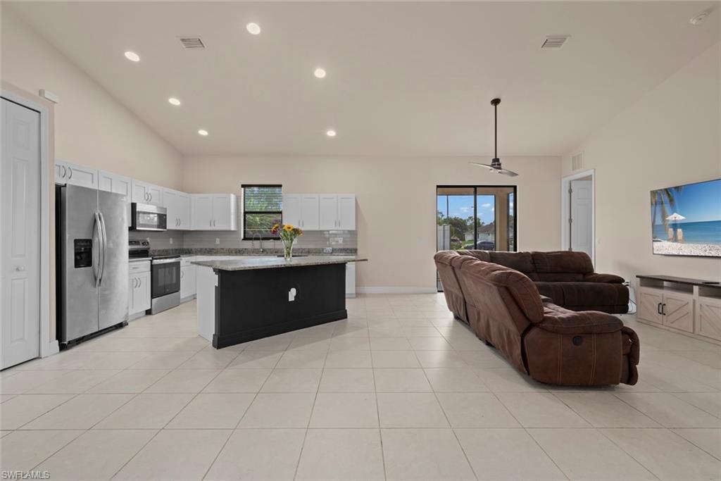 View of the kitchen and living space with vaulted ceilings and recessed lighting