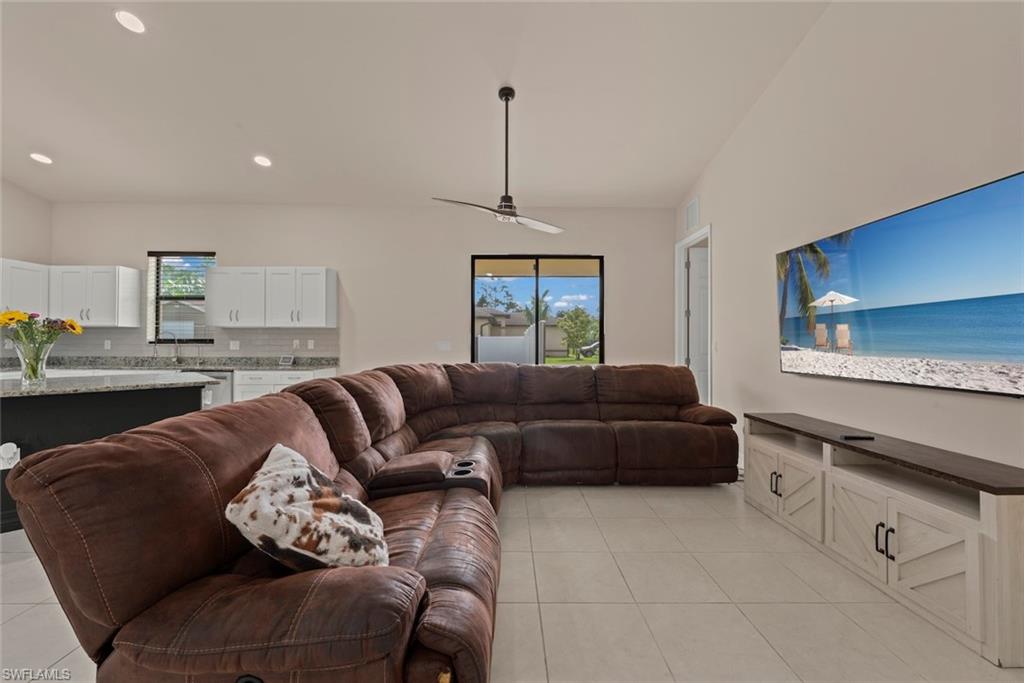 Recessed lighting, tile flooring, white shaker cabinetry, granite countertops, and a ceiling fan