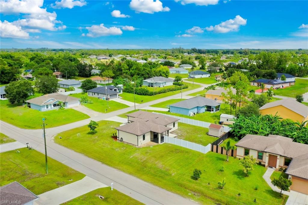 Residential neighborhood with paved roads, trees, and landscaping