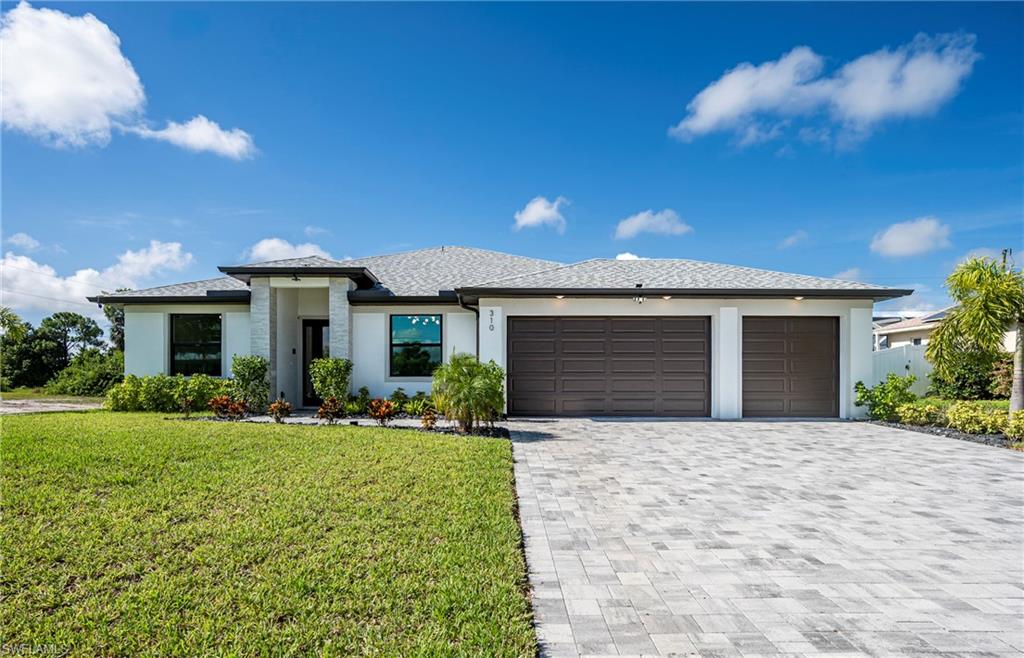 Front of Home with 3 Car Garage and Paver Driveway