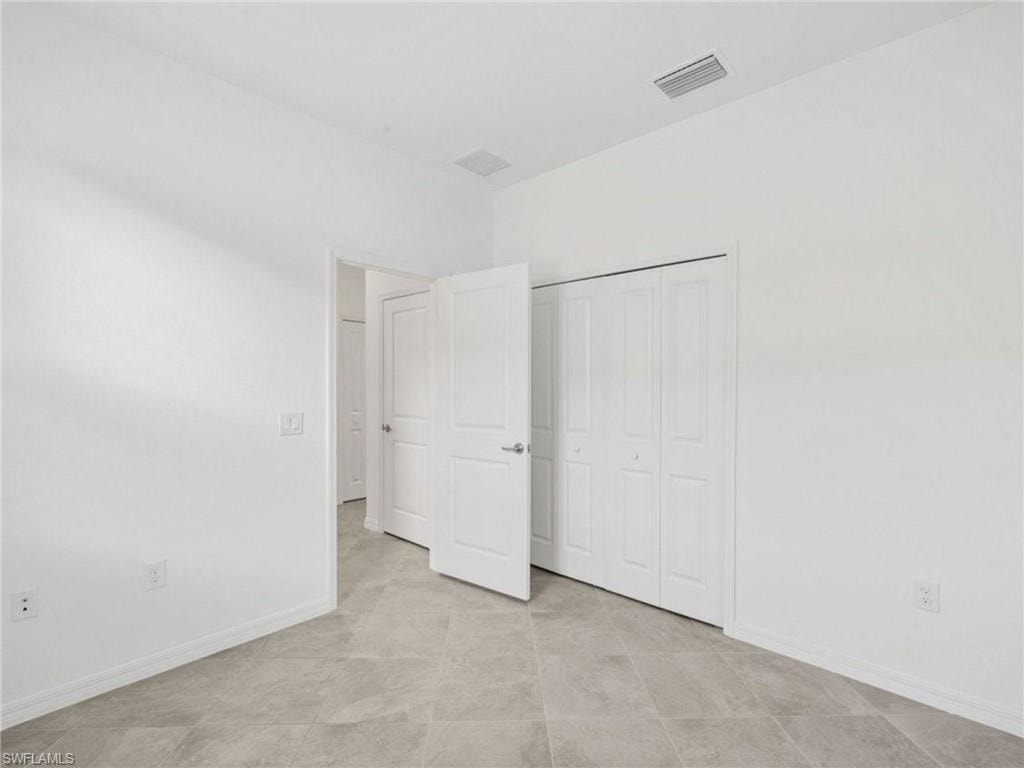 Comfortable guest bedroom with neutral finishes and ample natural light.