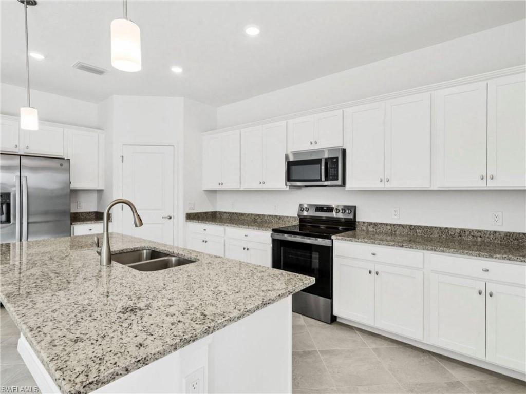 Modern kitchen featuring stainless steel appliances, abundant cabinetry and generous counter space.