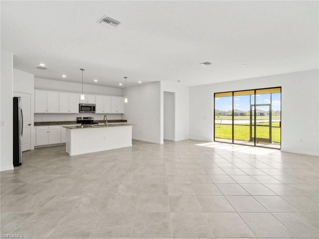 Open-concept living area filled with natural light and views toward the backyard and lake.