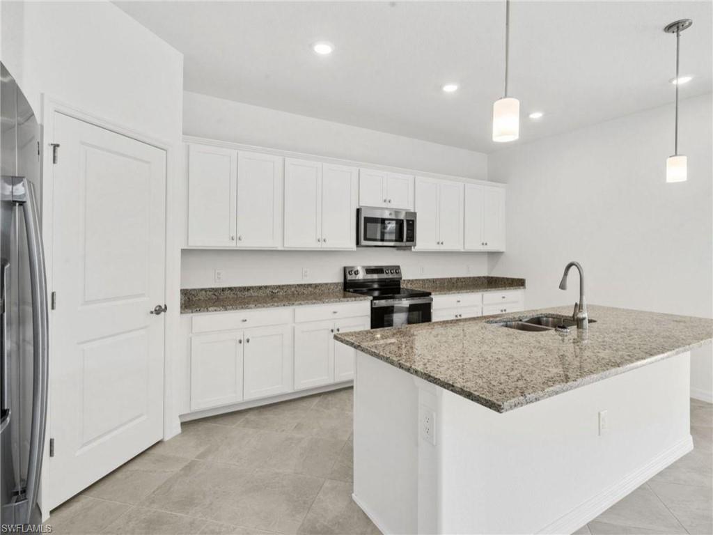 Spacious kitchen with center island, breakfast bar and plenty of prep space.