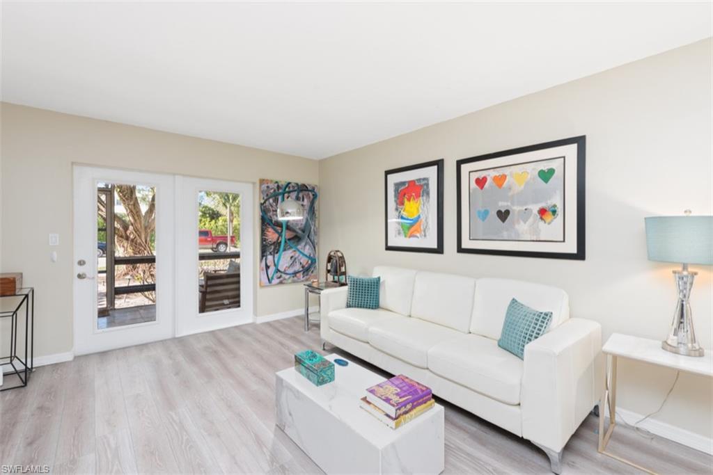 Living room with light hardwood / wood-style floors