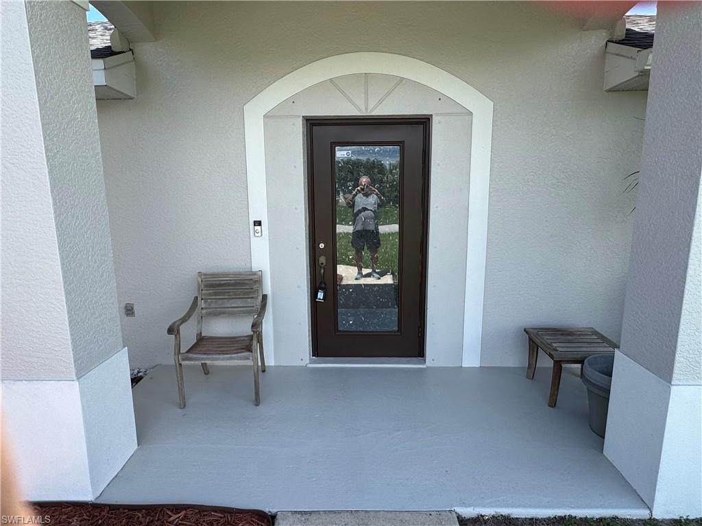 Doorway into home featuring front porch