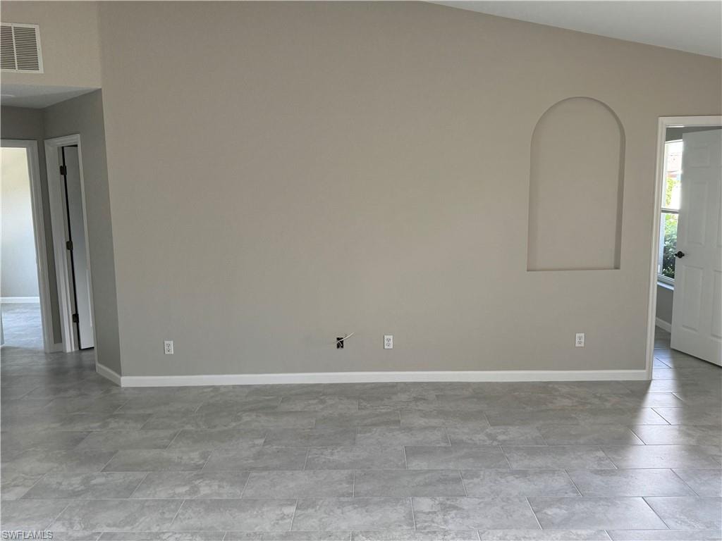 Family room featuring baseboards, niche and vaulted ceiling