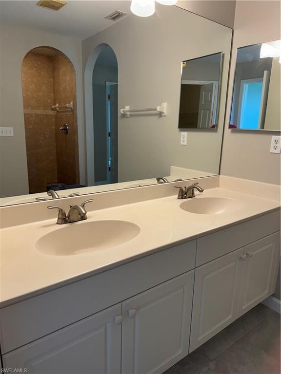 Primary bathroom featuring double vanity and medicine cabinet